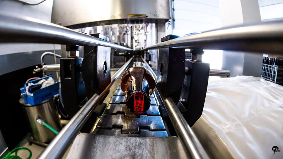 Close-up of a view of bottle at beer packaging machine at Elis Brewery plant